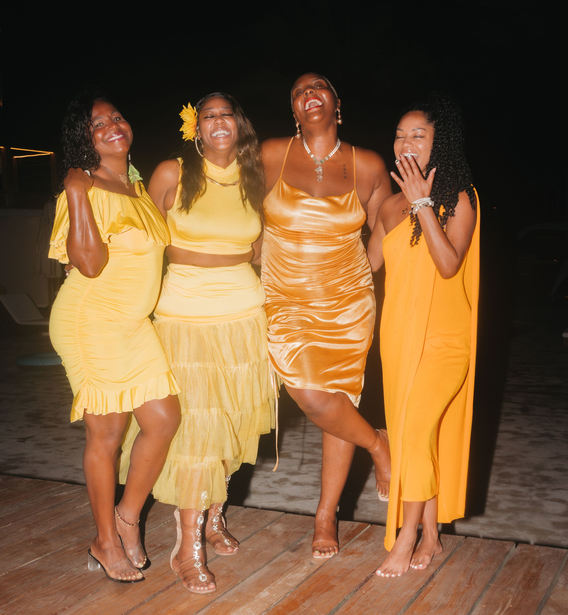 Four women from The Goddess Movement laughing together